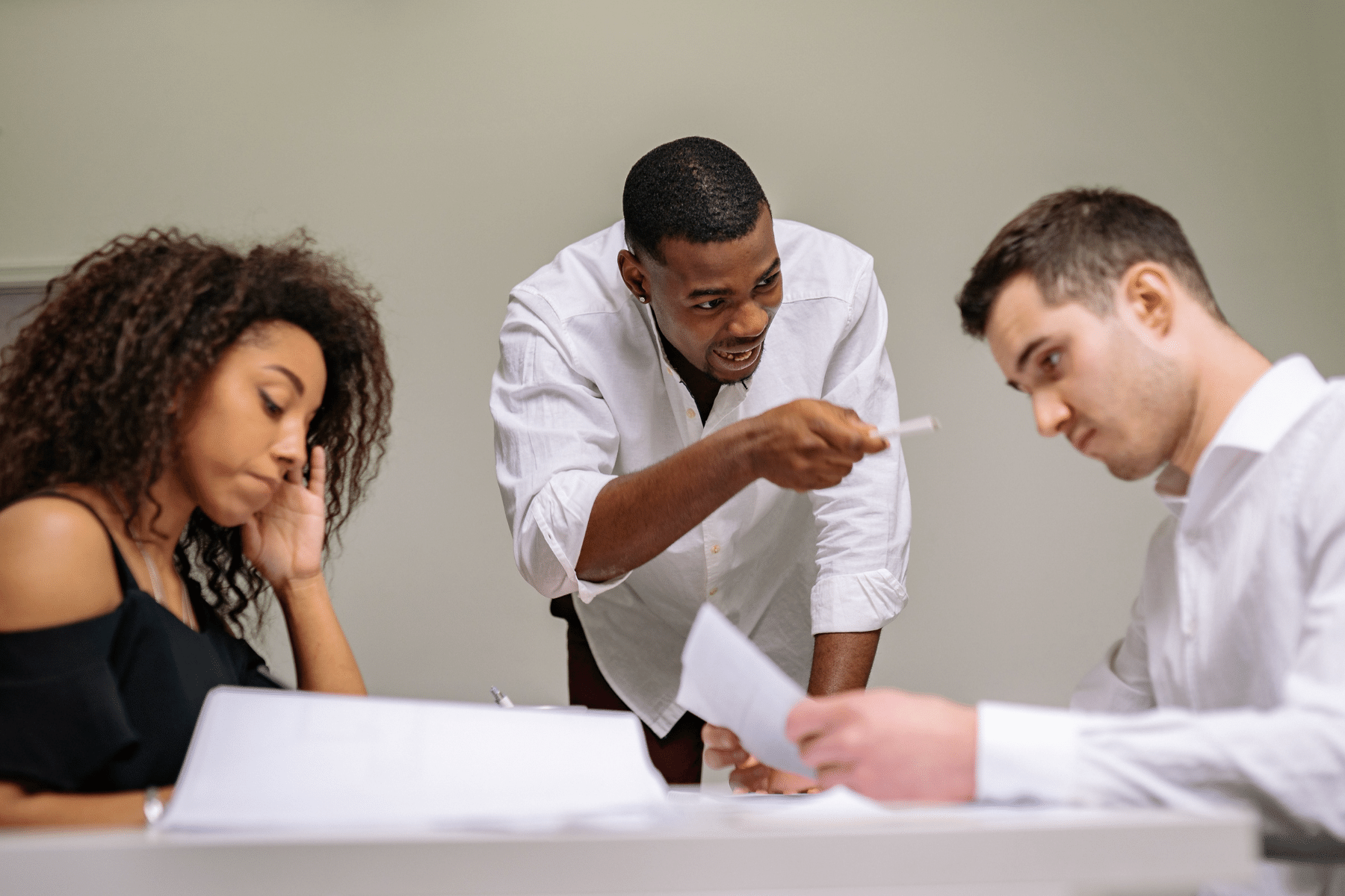 Woman being verbally scolded by someone in a workplace setting 